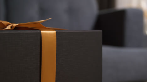 Close-Up-Of-Gift-Wrapped-Present-With-Bow-On-Table-In-Lounge-At-Home-3